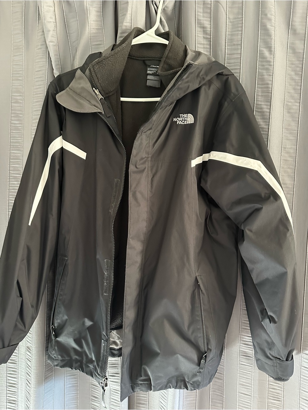The North Face Black Rain Jacket with White Stripe, removable fleece lining.